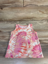 Flat lay of Cat & Jack toddler tank top showcasing pink and peach tie-dye spiral pattern with wood plank background