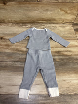 Top-down view of Cloud Island grey textured newborn shirt and pants set with white cuffs and collar on a wooden background