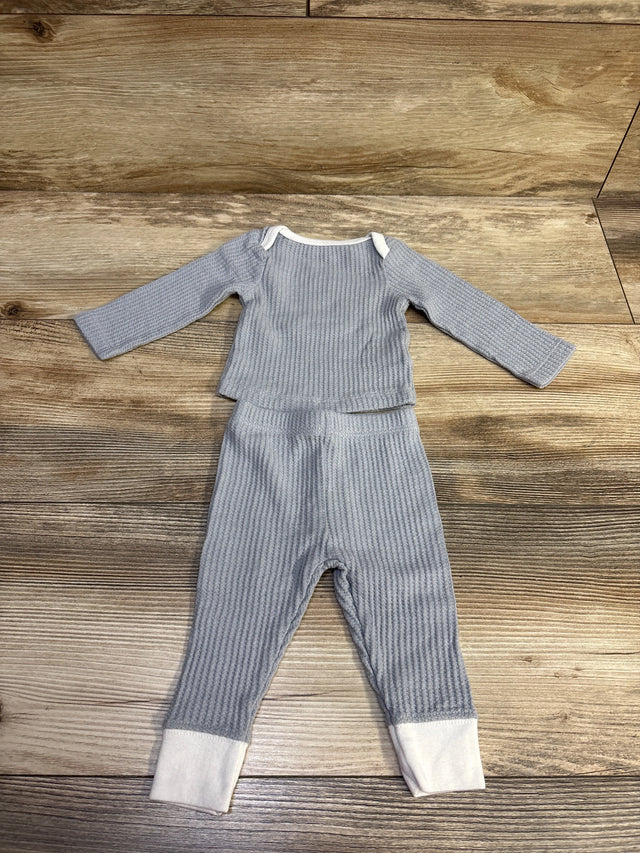 Top-down view of Cloud Island grey textured newborn shirt and pants set with white cuffs and collar on a wooden background