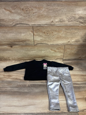 Top-down view of Disney Baby Minnie Mouse sweatshirt and leggings set showcasing a black sweatshirt and silver leggings on a wood floor