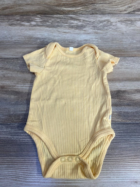 Top-down view of Mori yellow ribbed newborn bodysuit (0-3M) showcasing ribbed texture and three-snap crotch on wood background