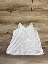 Flat-lay of white Cat & Jack toddler tank top, size 4/5T, with scoop neckline and sleeveless cut on wood floor