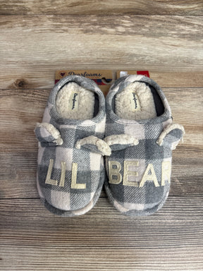 Children's plaid slippers with cream sherpa lining and "LIL BEAR" text on top, set on wooden surface