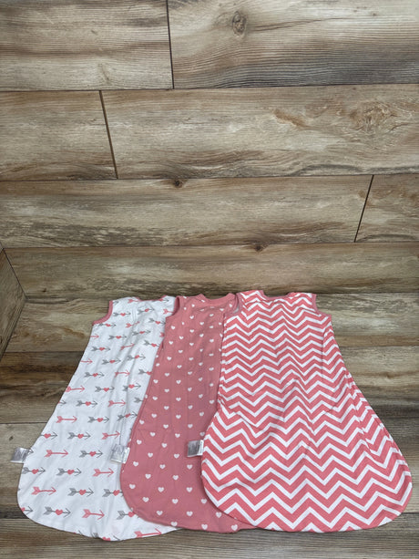 Top view of three Yoofoss sleep sacks in white and pink, showcasing arrow, heart, and chevron patterns on a wood background