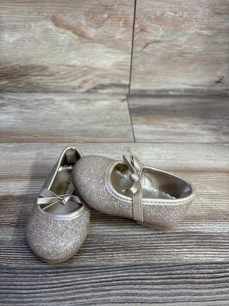 Angled front view of Koala Kids gold glitter bow ballet flats, size 3C, showing glitter finish and ribbon bow on wood background