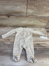 Front view of Carter’s beige striped sleeper in size 3 months, showcasing long sleeves and built-in footies on a wood floor