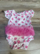 Pink strawberry print baby girl bodysuit with ruffled tutu on wood background