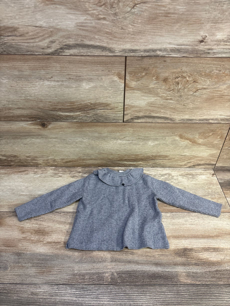 Grey Zara ruffle collar sweater for infants, size 6-9m, on a wooden background.