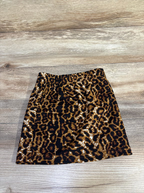 Flat lay of toddler leopard-print skirt showing elastic waistband and brown-black pattern on wooden floor