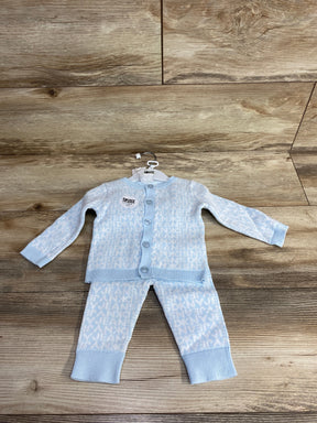 Light blue DKNY baby cardigan and pants set with button closure on wooden background