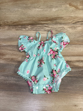 Top-down view of mint blue floral off-shoulder baby romper with ruffled sleeves and snap crotch on wood background