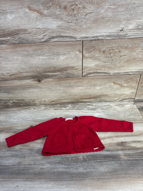 Flat lay of red Mayoral Swiss-dot knit baby cardigan (4–6 months) showing scalloped hem, single top button, long sleeves on wood background