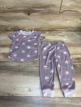 Purple floral toddler pajama set with short sleeves and elastic waist pants on wood floor