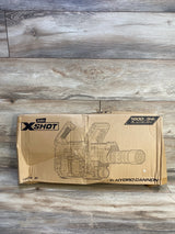 Front of Zuru X-Shot Hydro Cannon box showing line-art of the water gun and printed 1600 mL/54 fl oz claim on wooden floor