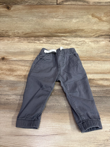 Grey Cat & Jack drawstring cotton joggers for babies size 12m on a wooden background