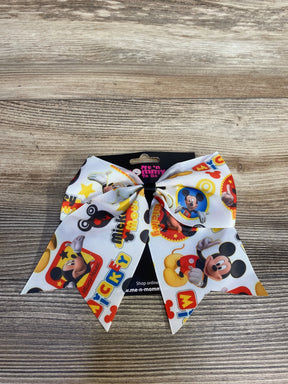 White Mickey Mouse themed bow with colorful cartoon prints on a wooden surface