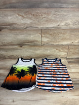 Flat lay of Wonder Nation 2-pack toddler tank tops showcasing left sunset palm print and right navy and white stripes on light wood background