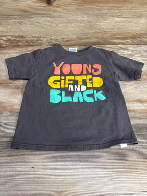 Front flat-lay of grey toddler T-shirt (4T) showcasing large colorful "Young Gifted and Black" graphic on a light wood background