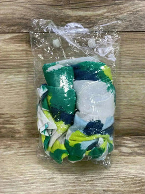 Folded Canopy Couture jersey stretch cover showing green, navy, and lime brush-stroke print in clear plastic bag on wood background