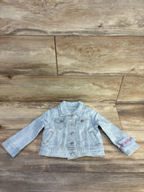 Front view of Cat & Jack light blue denim jacket (12M) showing buttons, chest pockets and faded wash on wood background