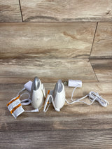 Angled front view of two VTech DM221 audio monitor units showing power adapters and cords on wood surface