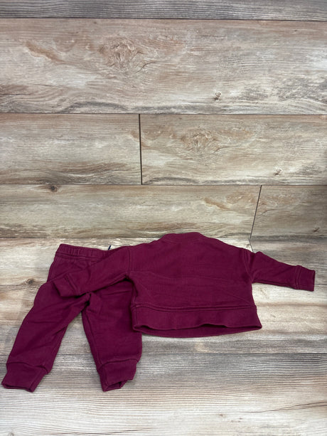 Back view of Wonder Nation 2pc half-zip sweatshirt and joggers set in maroon laid flat on a wood-look floor