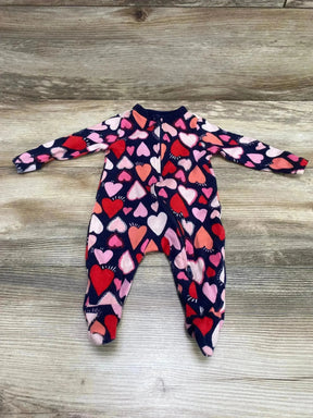 Top down view of Old Navy navy footed baby sleeper showing multicolor heart print and front zipper on light wood background