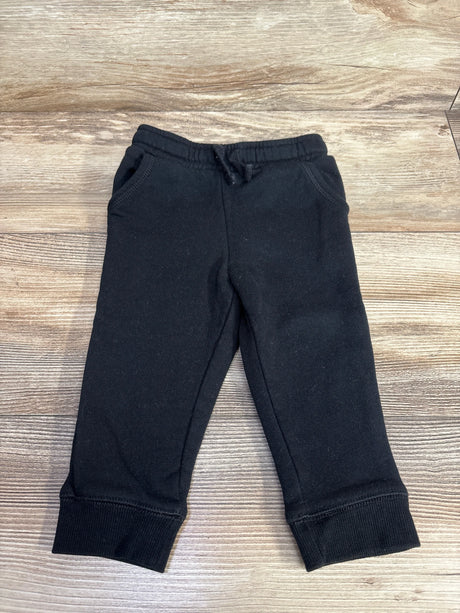 Black toddler jogger pants with elastic waistband and pockets on wooden background