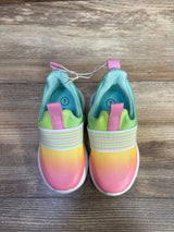 Top view of Cat & Jack rainbow slip-on sneakers with pink-yellow gradient, elastic band, pink tabs, size 7 on wood floor