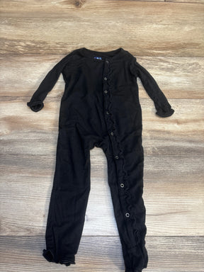 Black long sleeve baby romper with ruffle snaps, laid flat on wood background