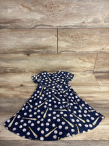 Navy blue toddler dress with baseball and bat print on wooden floor background
