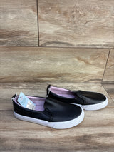 Three-quarter view of Cat & Jack Hailey toddler slip-on sneakers, black with elastic sides and white sole on white background