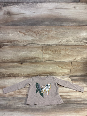 Front view of brown Pekkle long-sleeve toddler shirt (3T) showcasing astronaut and rocket graphic on wood plank background