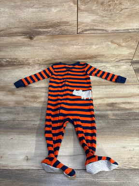 Orange and navy striped baby sleeper with white rhino patch on wood floor