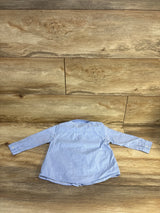 Light blue kids long sleeve button-up shirt on wood floor, kids clothing resale