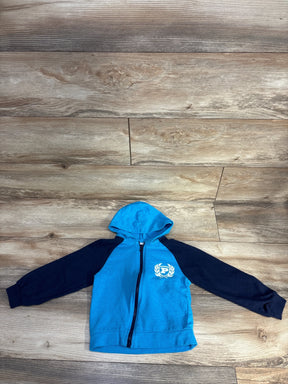 Blue and black kids zip-up hoodie with hood, emblem on chest, on wood background