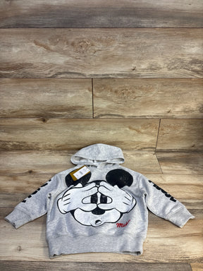 Gray kids Mickey Mouse hoodie with graphic print, laid on wood floor, great for toddler clothing resale