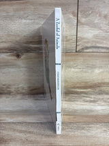 Spine view of A Zooful of Animals hardcover book by Cole and Munsinger showcasing white spine with blue title text on wood plank floor