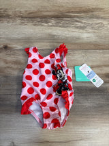 Pink Minnie Mouse baby swimsuit with red polka dots and ruffles, eco-friendly lining tag