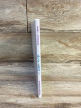 Spine view of Now What hardcover book by Faatz and Trimarco showcasing white spine with Notable Kids Publishing label on wood plank floor