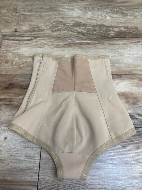 Front view of Bellefit postpartum girdle corset in beige, showcasing stitched panels and front zipper on wood background