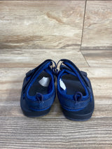 Rear view of Old Navy navy toddler double-strap sandals showing heel pull loops and Velcro straps on wood floor background