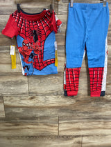 Child's two-piece Spider-Man pajama set with red, blue, and black web design on wooden floor