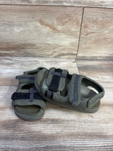 Angled top view of Zara Scuba toddler sandals showcasing two adjustable Velcro straps and breathable mesh upper, size 7C on wood grain background