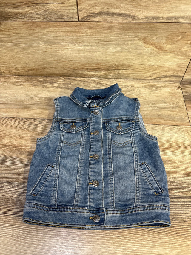 Flat lay view of Cat & Jack toddler denim vest size 5T showcasing button-front closure, flap chest pockets, and light blue wash on wood background