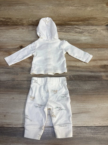 White baby hoodie and pants set with animal print, laid on wood background