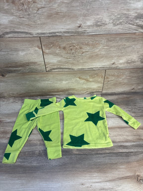 Green toddler pajama set with dark green stars, long sleeves and pants on wood floor