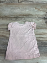 Back view of girls' pink Beautees shirt (size 3T) showing puff sleeves and crew neck laid flat on wood floor
