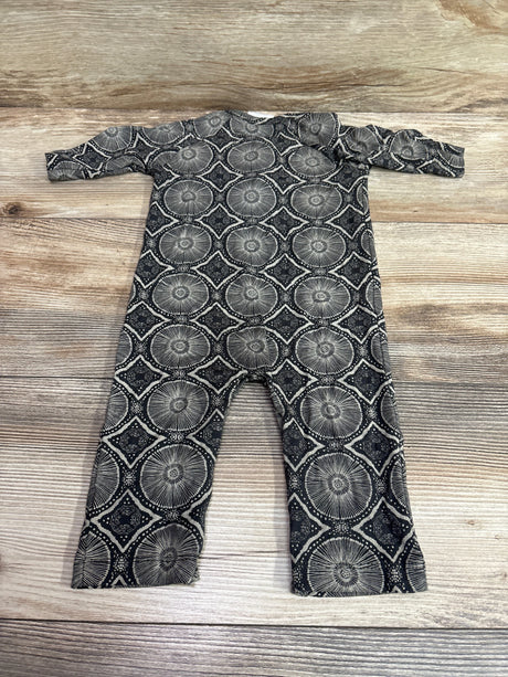 Flat lay of The Woods by Kate Quinn Beechwood Modal Coverall showcasing grey circular geometric pattern on wood background
