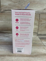 Back view of NEW Proof Reusable Postpartum Underwear High Rise Brief sz Large packaging showcasing washer and dryer care instructions on pink box on wood plank floor